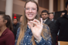 A student at the Order of the Engineer Induction Ceremony shows off the stainless steel ring, which symbolizes her dedication to upholding the standards and dignity of the engineering profession.