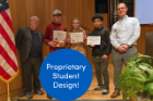A student team receives an award for their EAS 199 design project.