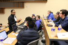A faculty mentor meets with students during a EAS 199 class.