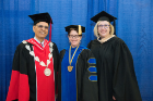 Ann Wegrzyn (BS IE ’85; MBA ’90) received the Dean’s Award from the School of Engineering and Applied Sciences. She is shown with (from left) Satish Tripathi, UB president, and Ann Bisantz, professor and chair of the Department of Industrial and Systems Engineering. Photo credit: The Onion Studio.