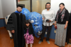 student with family at graduate commencement reception. 