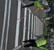 Two IISE members user rollers to paint a crosswalk.