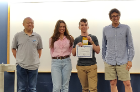Nathan Margaglio earned first place in the Reinforcement Learning Challenge. From left is Wen Dong (CSE faculty member and judge), Nathan Margaglio, Alina Vereshchaka (organizer) and Kenny Joseph (CSE faculty member and judge).