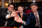 Students at the Order of the Engineer Induction Ceremony show off the stainless steel ring, which symbolizes their dedication to upholding the standards and dignity of the engineering profession.