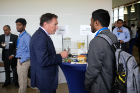 Keynote speaker Mark Santoro, a principal engineering fellow for Space and Airborne Systems in the Hardware Engineering Center at Raytheon, talks with a student during the Career Preparation Reception. Santoro is an electrical engineering alumnus of UB.