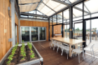 The UB GRoW Home's GRoWlarium, a 340-square-foot, glass-enclosed sunroom that doubles as a greenhouse for growing food year-round. Photo: Thomas Kelsey/U.S. Department of Energy Solar Decathlon