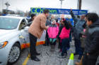 Dennis Elsenbeck, regional director for National Grid, shows students an electric car plugged into one of 21 charging stations on the Buffalo Niagara Medical Campus. Photo: Nancy J. Parisi