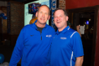 Bulls Head Football Coach Lance Leipold, left, chats with former Bulls broadcaster Paul Peck. Photo: Douglas Levere