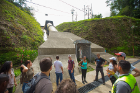 Students tour the Los Negros hydroelectric plant and pass a religious statue along the way.