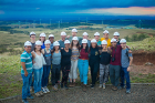 Members of John Atkinson's course, "Costa Rica: Sustainability in Latin America," pose for a picture with the Celsia wind project turbines in the background.