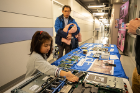 Claire, 4, and her dad, biomedical engineering professor Rougang Zhao, look at computer parts. 
