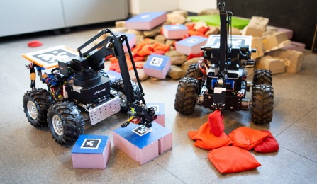 Two robots sort blocks and beanbags. 