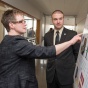 Professor talks to a student about his project at the Senior Design Expo. 