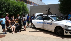 Students checking out UB's autonomous vehicle. 