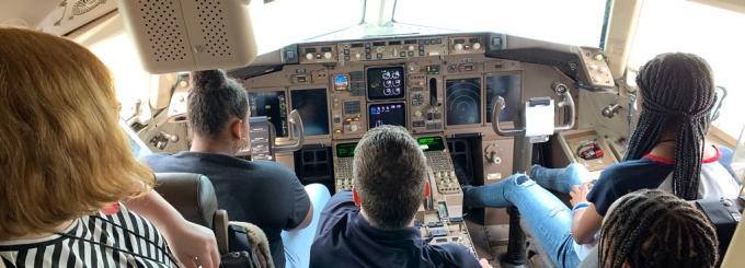 campers touring an airplane cockpit. 