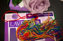 Lavender ceremony program and rainbow tassel. 