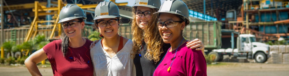 Four women in hard hats touring a Sugar Mill in Costa Rica as part of an Environmental Engineering class researching sustainability. 