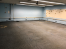 June 17, 2019. Custodial Services has completely cleared the lab of debris. Note the extraneous cabling on the east wall, including a bank of dangling, disused telephone lines. This space must have been used as a call center at some point.