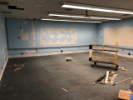 July 19, 2019. Dave, Carl, and Artie from the Paint Shop have begun patching the walls and have painted the wire mold raceways. Grant from Network and Classroom Services has removed the extraneous cabling visible in the previous image.