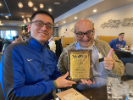 Zhen Liu hands Charlie Tirone his 2021 CSE Outstanding Service Award at Zoe restaurant, January 15, 2022. 