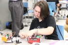 A team works through the challenge of combining building hardware, wiring, the electronics, and programming the behavior of the robot.