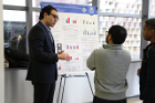 Abdul Hassaballah talks about his poster with fellow graduate students at the competition.