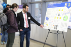 Jafari Amin talks about his poster with fellow graduate students at the competition.