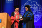 Professor Rohini Srihari accepted the President's Medal from UB President Satish Tripathi on behalf of her late husband, SUNY Distinguished Professor Sargur "Hari" Srihari, who passed away in March.