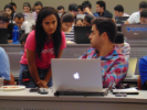 Nisha Chaudhari (left) providing help to a students during the Google Games event. 