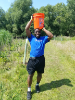 Research methods instructor and chemical engineering doctoral student Ogechi Ogoke helps to plant trees during a community service outing to Tifft Nature Preserve. 