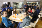 Attendees enjoy pizza and socialize at the 2018 Engineer Alley basketball game.