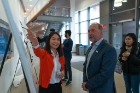 Soojung Baek, Department of Materials Design and Innovation, discusses her poster on"Exotic Decision Making for Guided and Autonomous Experiment in Material Science" with UB civil engineering alumnus Stephen Still.