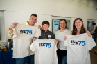 Members of Mark’s family pose with ISE 75th anniversary t-shirts.