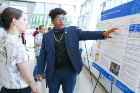 Brandon Manley (right) discusses his research on optimizing physical properties in dental resin. Manley worked with Chong Cheng, a professor in the Department of Chemical and Biological Engineering.