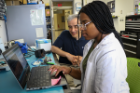 Christine Shiyam (right), a computer engineering major works with mechanical and aerospace engineering professor John Crassidis (center), on the observation of cosmic rays and atmospheric data. 