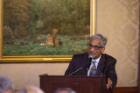 Krishna Rajan speaking at dinner at Butler Mansion. 