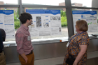 Eric Oliverio and Lauren Aslplen discussing his poster at poster session. 