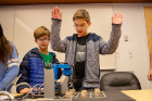 Brothers Lucas (left) and Henry Strong play some robot tic-tac-toe and appear to be enjoying some success.