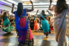 Members of the bride's party take their turn performing a traditional dance.