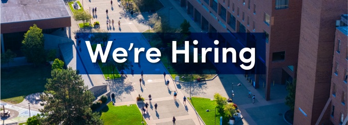Text "We're Hiring" over an aerial view of North Campus. 