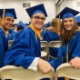 Group of UB students at commencement in caps and gowns. 