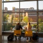 students studying in front of a window. 