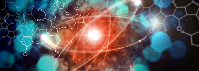 Abstract scientific illustration showing a glowing atom-like structure at the center, with bright red and orange light radiating outward. Curved orbital paths loop around the central core, suggesting electrons or energy movement. Semi-transparent molecular diagrams and hexagonal chemical structures overlay a deep blue and teal background, creating a layered, futuristic visualization associated with physics or chemistry concepts. 