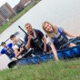 Students in a concrete canoe on the water near the shoreline. 