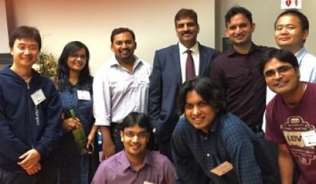 Zoom image: Vice President for Research And Economic Development Venu Govindaraju is flanked by Bay Area UB alumni at UBay '15 