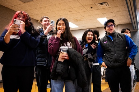Zoom image: UB students take photos and smile at an engineering event