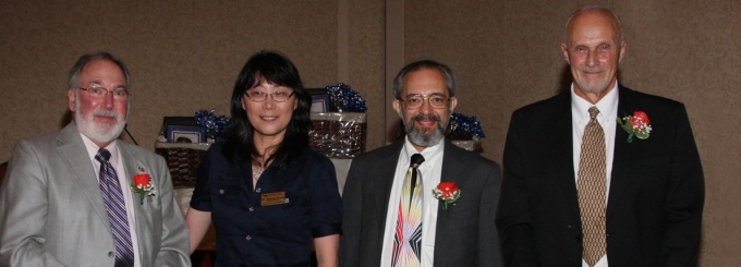 Zoom image: Stuart Shapiro, CSE Department Chair Aidong Zhang, William Rapaport, and Peter Scott at Stu, Bill, and Peter's retirement dinner at Salvatore's Italian Gardens in 2011 