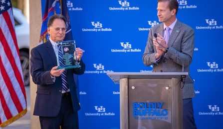 Zoom image: CSE Departmental Advisory Board Co-Chair Russ Agrusa receives a glass sculpture at the Paula T. Agrusa Plaza dedication ceremony, November 5, 2021. 