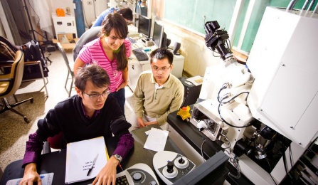 Five students collaborate in a university laboratory. 