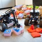 Two robots sort blocks and beanbags. 